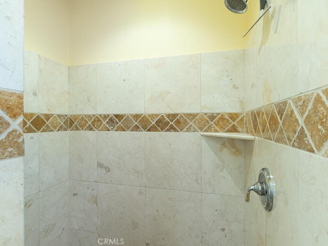 interior details featuring a tile shower