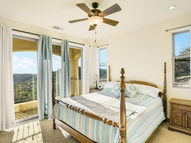 bedroom with visible vents, light carpet, access to exterior, and a ceiling fan