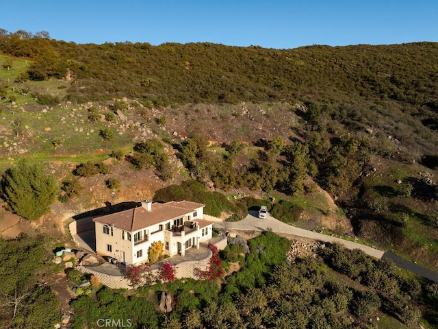 drone / aerial view featuring a forest view