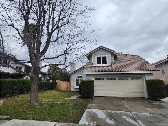 view of front of property featuring a front lawn, a tile roof, fence, concrete driveway, and a garage