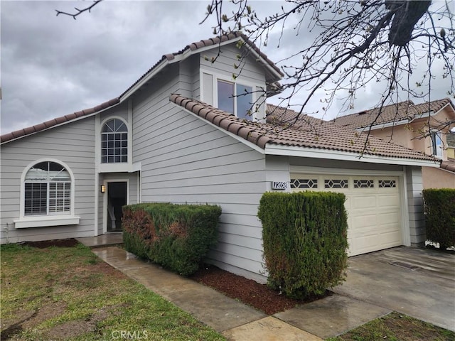 view of front of home with a garage and a tiled roof