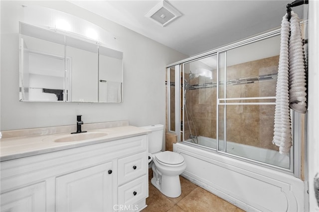 full bathroom with tile patterned floors, visible vents, toilet, bath / shower combo with glass door, and vanity