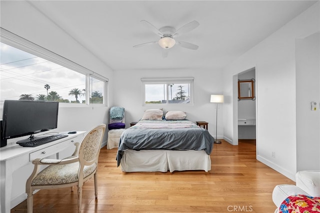 bedroom featuring light wood finished floors, ceiling fan, and baseboards