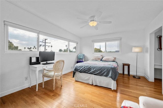 bedroom featuring ceiling fan, baseboards, and wood finished floors