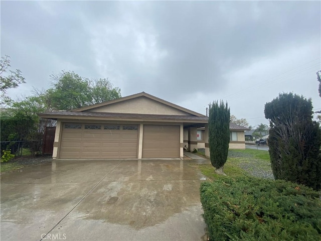 view of front of house featuring stucco siding, driveway, and a garage