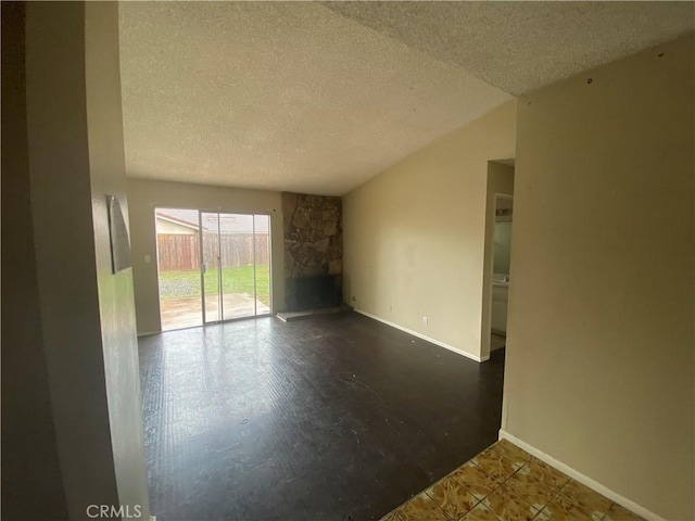 empty room with baseboards and a textured ceiling