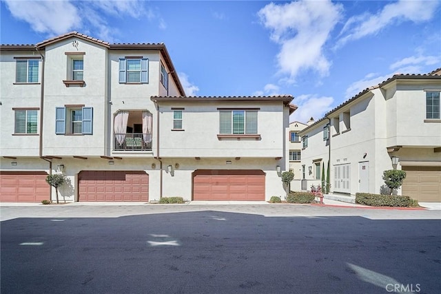 townhome / multi-family property featuring stucco siding and a garage