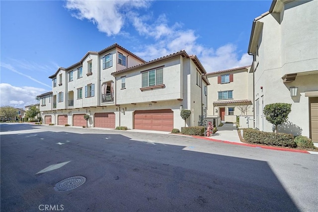 view of building exterior featuring a residential view and an attached garage