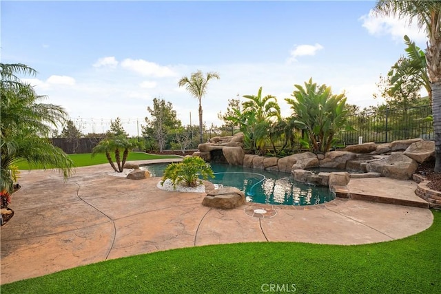 view of pool with a patio area, fence, a fenced in pool, and a lawn