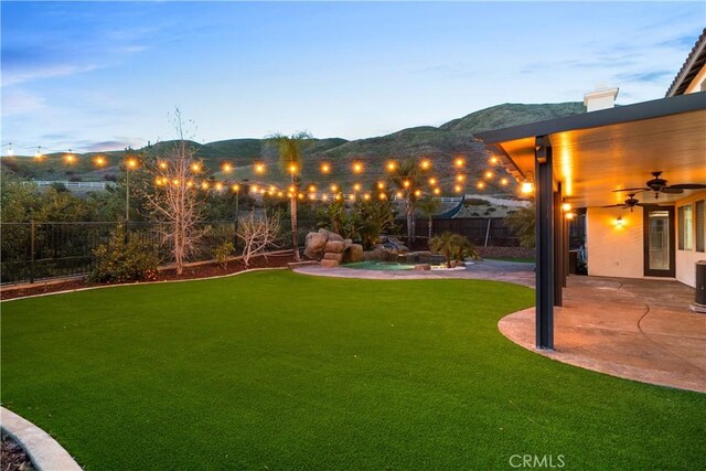 33740 Old Trail Dr, Yucaipa, CA 92399 - view of yard featuring a ceiling fan, a patio area, and a mountain view