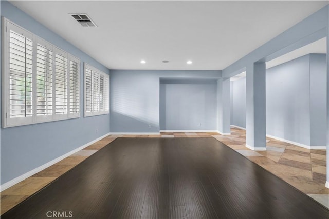 interior space with baseboards, visible vents, recessed lighting, and wood finished floors