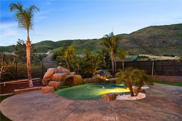 33740 Old Trail Dr, Yucaipa, CA 92399 - view of pool featuring a mountain view, a fenced backyard, and a patio area