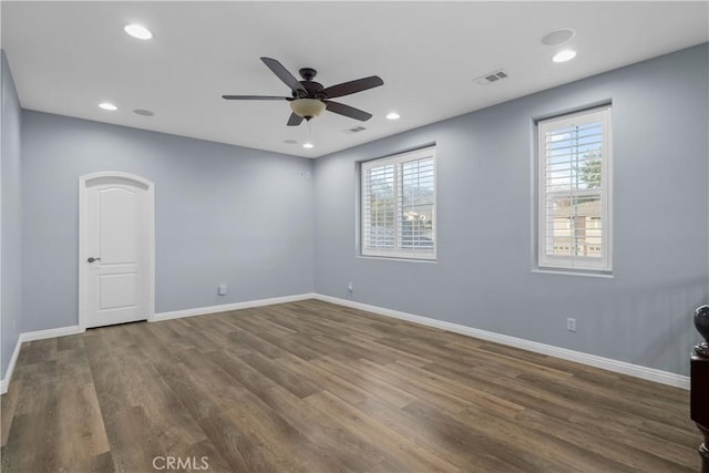 spare room featuring wood finished floors, baseboards, visible vents, ceiling fan, and recessed lighting