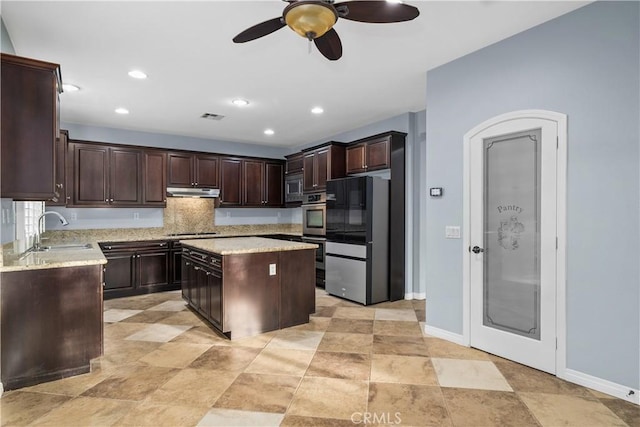 kitchen with stainless steel appliances, a sink, ceiling fan, visible vents, and dark brown cabinets