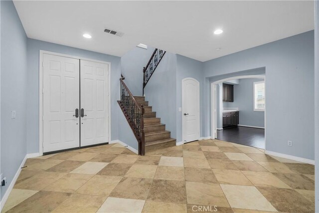 33740 Old Trail Dr, Yucaipa, CA 92399 - entrance foyer featuring arched walkways, stairway, baseboards, and recessed lighting