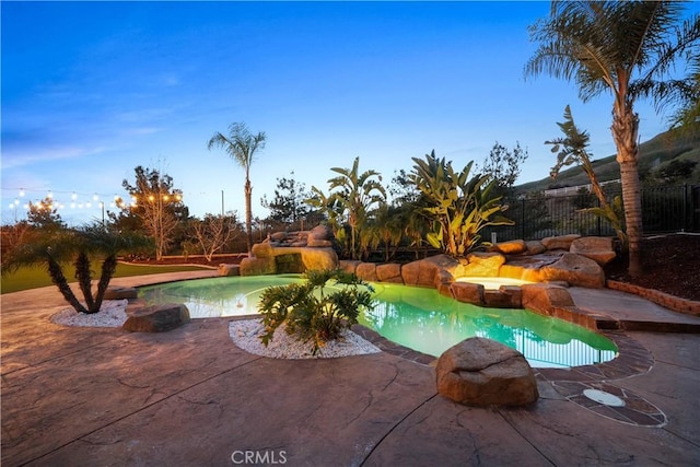 view of swimming pool with a fenced in pool, fence, and a patio area