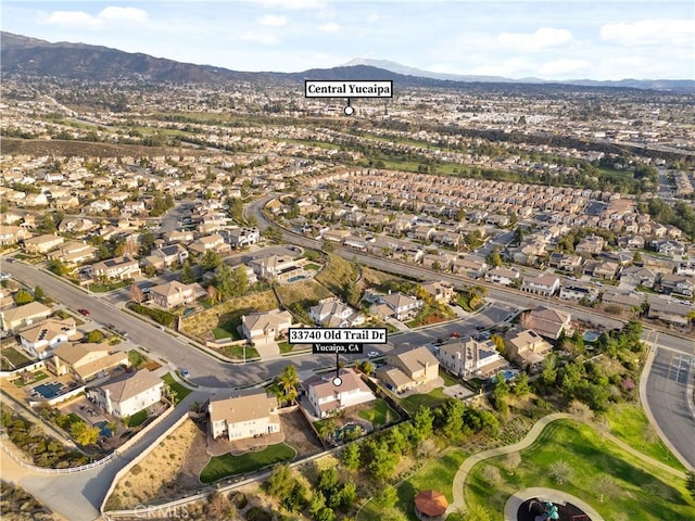 drone / aerial view featuring a residential view and a mountain view