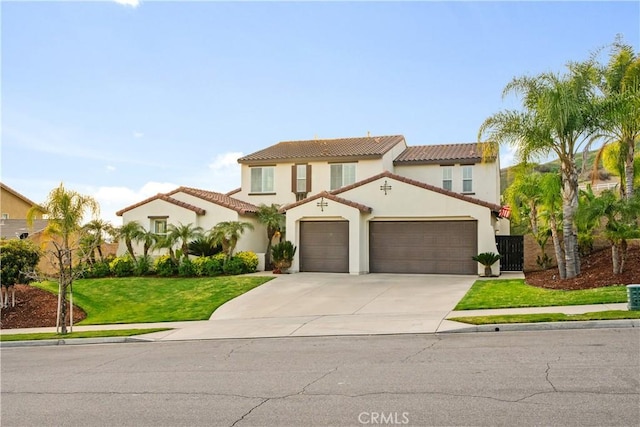 mediterranean / spanish-style house featuring a tiled roof, concrete driveway, a front yard, stucco siding, and an attached garage