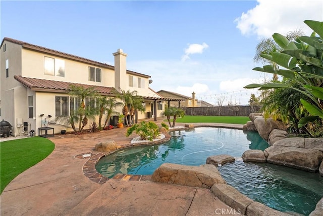 view of swimming pool with a fenced in pool, a patio, a yard, and fence