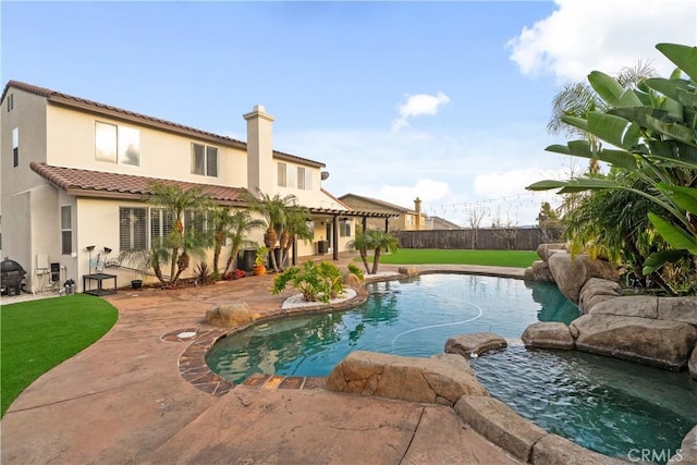 view of pool with a fenced in pool, a lawn, fence, and a patio area