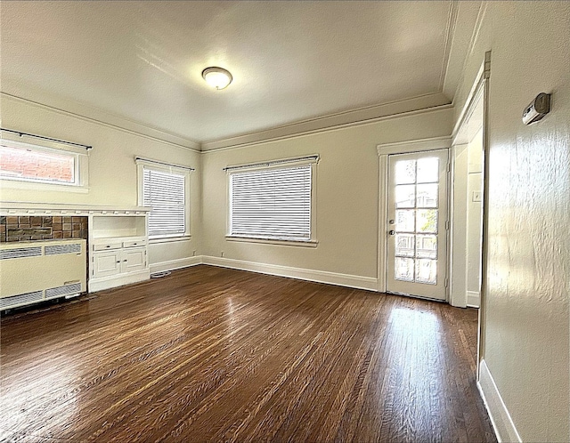 332 W 9th St, Long Beach, CA 90813 - unfurnished living room with ornamental molding, dark wood-style floors, heating unit, and baseboards
