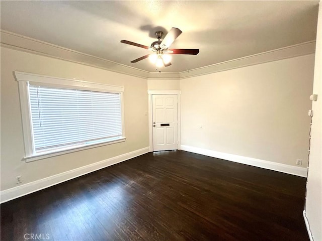 unfurnished room featuring baseboards, ornamental molding, and dark wood-style flooring