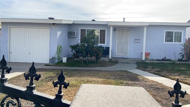 bungalow-style house with stucco siding and an attached garage