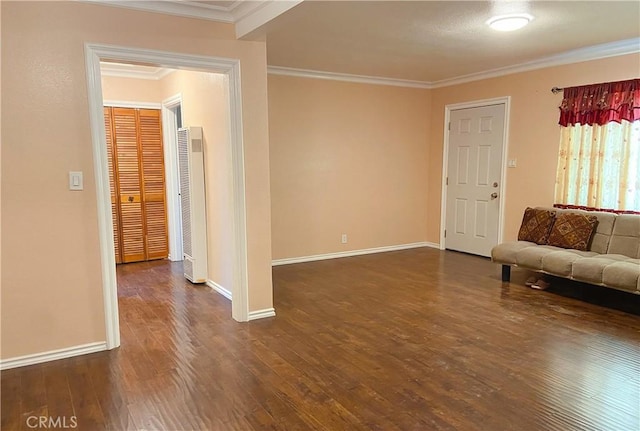 unfurnished living room with wood finished floors, baseboards, and ornamental molding