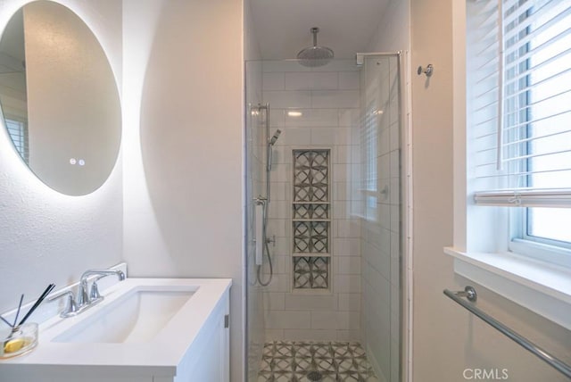 bathroom with vanity and a shower stall