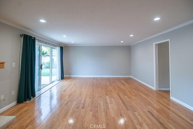 unfurnished room featuring light wood finished floors, baseboards, and ornamental molding