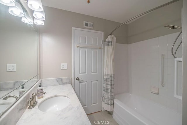 full bathroom featuring vanity, wood finished floors, visible vents, and shower / tub combo with curtain