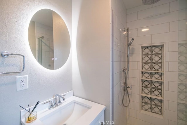 bathroom featuring vanity and a tile shower