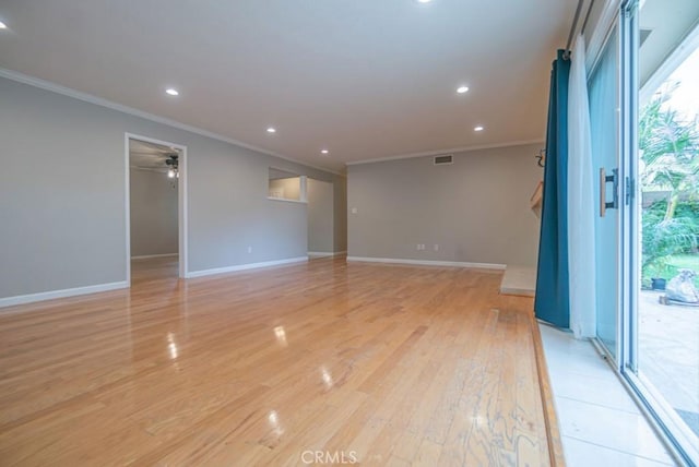 empty room with baseboards, recessed lighting, light wood-type flooring, and ornamental molding