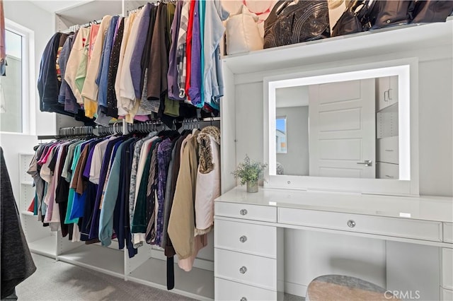 walk in closet featuring carpet flooring