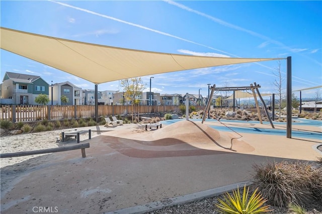 view of jungle gym with a residential view and fence