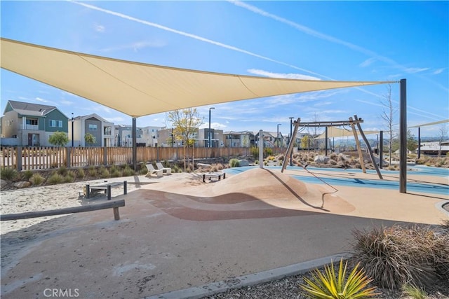 view of playground featuring a residential view and fence