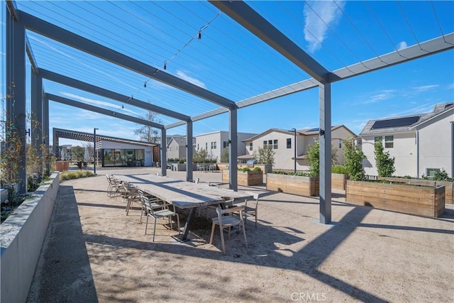 view of patio featuring a pergola, a residential view, and fence