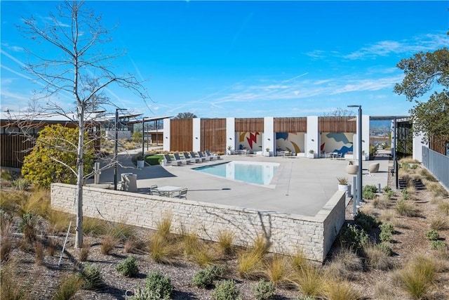 community pool featuring a patio area and fence