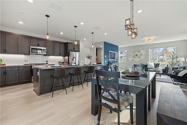 dining area featuring recessed lighting, visible vents, and light wood-type flooring