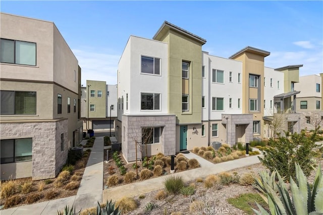 view of property featuring cooling unit and a residential view