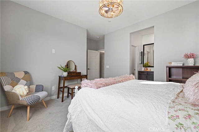bedroom featuring baseboards, connected bathroom, a notable chandelier, and light carpet