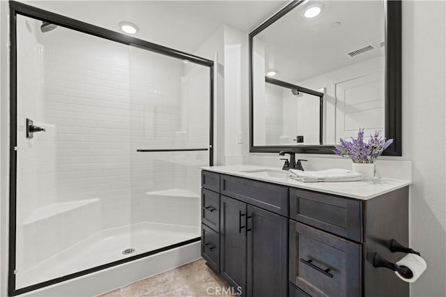 bathroom featuring visible vents, a shower stall, vanity, and tile patterned flooring