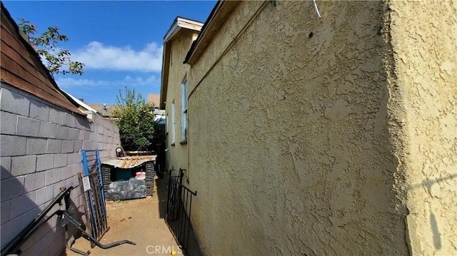 view of home's exterior featuring stucco siding and fence