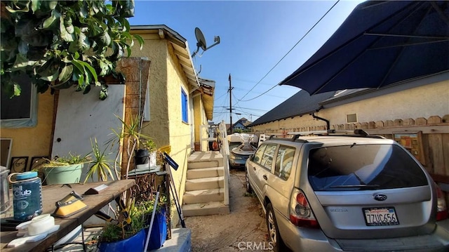 view of side of home with stucco siding