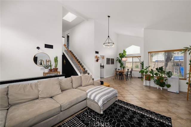 living room featuring stairs, light tile patterned flooring, baseboards, and high vaulted ceiling