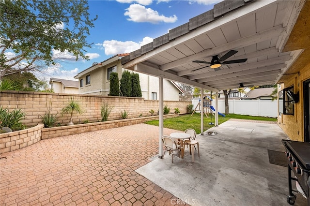 view of patio / terrace with a fenced backyard, a ceiling fan, and a playground