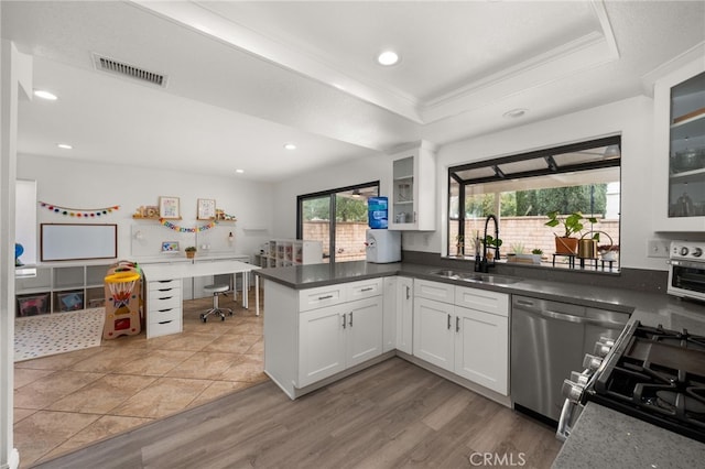 kitchen with visible vents, crown molding, dishwasher, a raised ceiling, and a sink