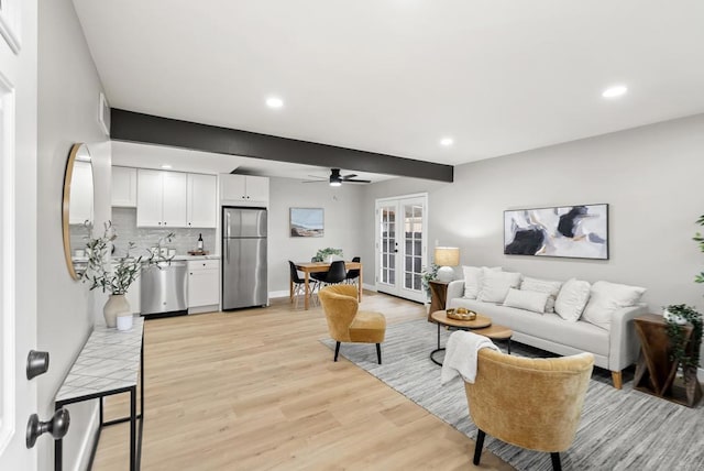 living room featuring recessed lighting, french doors, light wood-style floors, and baseboards