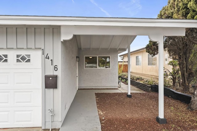 entrance to property featuring stucco siding and board and batten siding