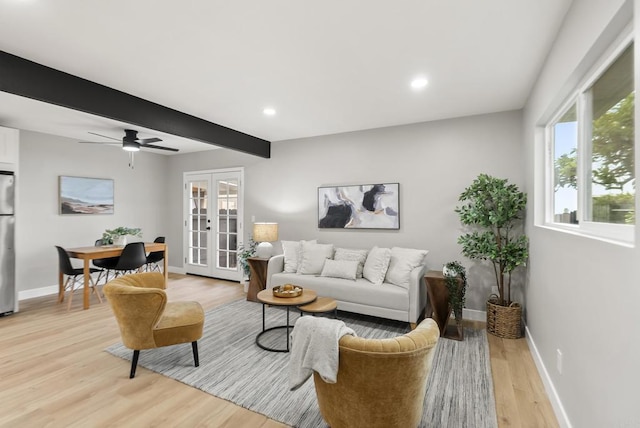 living area with beamed ceiling, light wood-style flooring, french doors, and baseboards